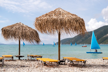 Thatch umbrellas on the beach in Greece