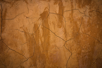 Fototapeta na wymiar Brown clay earthen wall texture or background