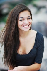 Obraz premium Happy long hair woman laughing with eyes closed, close-up.