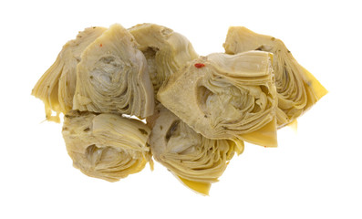 Marinated artichoke hearts on a white background top view.