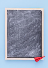 Back to school background with chalkboard and paper plane. Copy space.