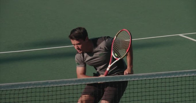 Tennis player stretches to make return in a match