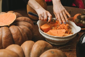 woman hands curving pumpkin