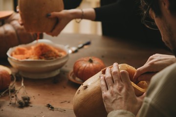 woman hands curving pumpkin