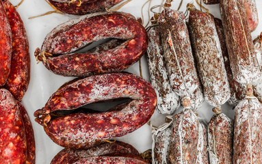 Flat lay top view of traditional Italian delicatessen salami sausage
