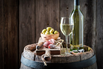 Chardonnay wine with olives and cold cuts