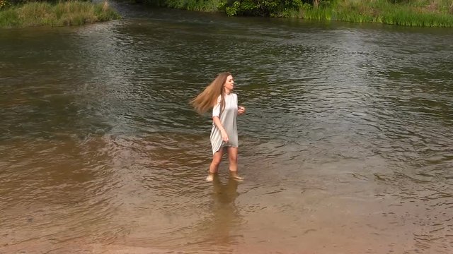 Attractive Caucasian Teen Girl Standing In River With Gray Dress
