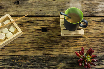 A glass of hot tea on old wooden table.
