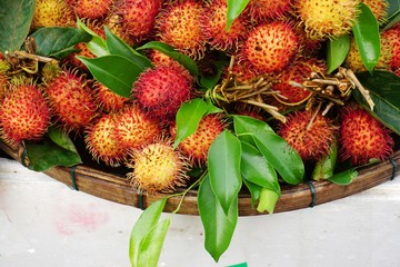 Fototapeta premium Red rambutan fruit for sale at a market in Vietnam