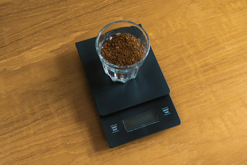 Barista Tools, Ground Coffee and Digital Scale on Table