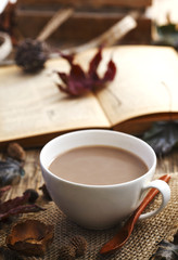 Autumn composition with cup of hot chocolate and book.
