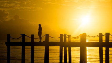 Lonely Woman Alone on Yellow Sunset Island Pier - El Nido, Palawan - Philippines