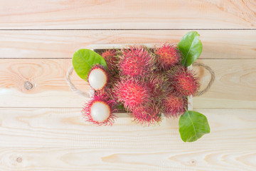 Rambutan fruit in box onwooden background