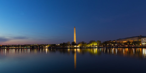 Fototapeta na wymiar Washington DC panorama near Tidal Basin at sunrise. Washington Monument and city lights reflection in water.