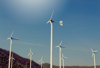 Fototapeta premium Wind Turbine for alternative energy, on background Sky and mountain
