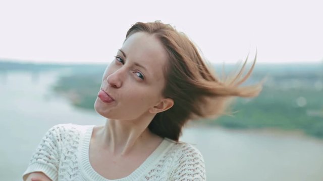 Woman looking at camera and making funny face, close-up