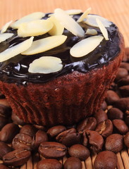Chocolate muffins with sliced almonds and coffee grains
