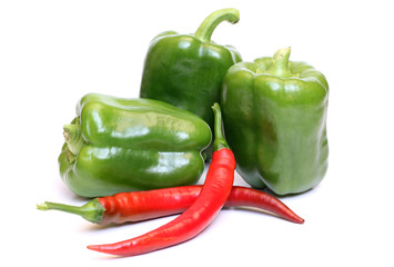 Green and red pepper on white background