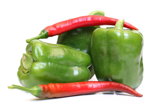 Green and red pepper on white background