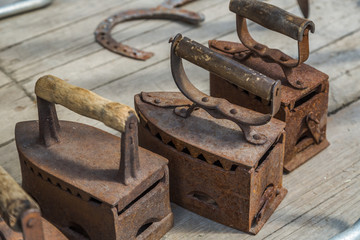 Old irons on wooden boards