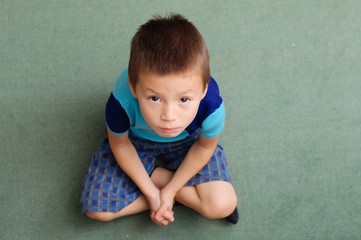 Fototapeta premium Upset boy portrait looking up
