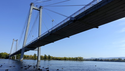 pedestrian bridge on the river in summer Sunny day