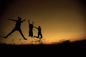 Silhouette woman jumping at sunset