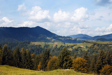 Autumn mountain landscape with blue sky with clouds