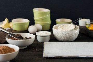 Ingredients for preparing delicious chocolate dessert on wooden