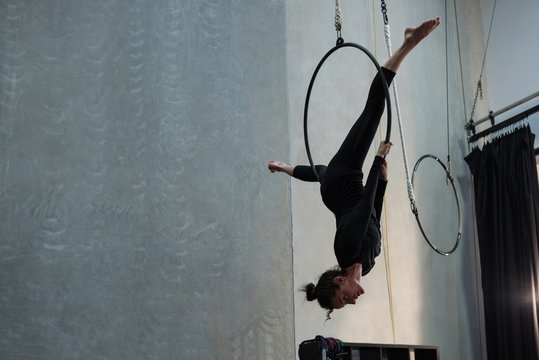 Female gymnast performing acrobatic gymnastics on hoop