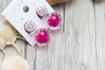 earrings on wooden background