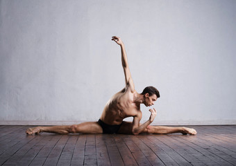 Young and fit modern dancer performing a move