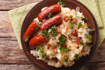 stamppot mashed potatoes, cabbage and carrots, with sausages close-up. horizontal top view
