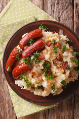 stamppot mashed potatoes, cabbage and carrots, with sausages close-up. vertical top view