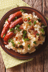 Dutch cuisine: stamppot from potatoes, sauerkraut and carrot close-up. vertical top view