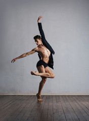 Young and fit modern dancer performing a move
