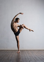 Young and fit modern dancer performing a move