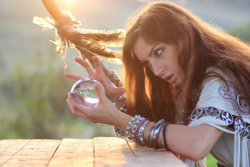 witch with crystal ball at sunset