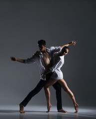 Fototapeta na wymiar Couple of sporty ballet dancers in art performance