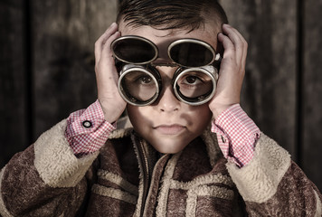 boy with welding glasses,an unusual portrait of the beautiful boy with short hair