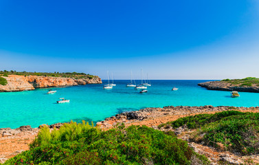 Fototapeta premium Idyllic view to the bay Cala Varques with turquoise water and boats at Majorca Spain