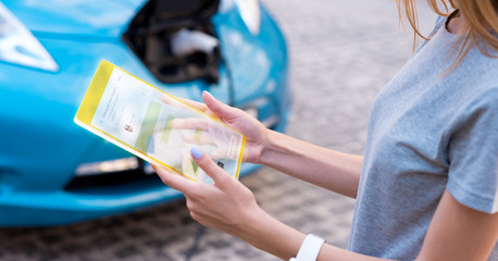 Pleasant young woman using modern device