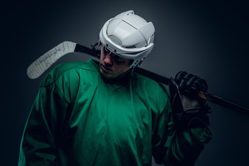 Naklejka premium Hockey player holds gaming stick.