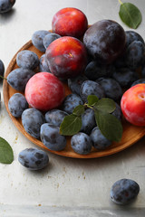 Ripe plums on plate closeup