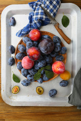 Ripe plums mix and knife