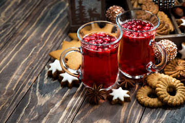 Christmas hot cranberry tea and cookies on dark background