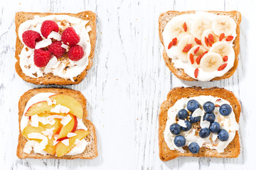 sweet toast with different toppings on white wooden table