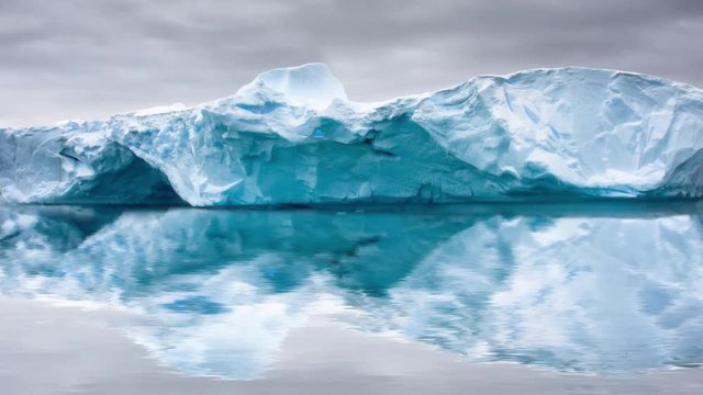 Big glacier in the snow with reslection in water. Slow motion 4K footage