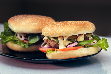  Two finished hamburgers on the plate. Cooking burger concept