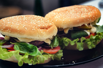  Two finished hamburgers on the plate. Cooking burger concept